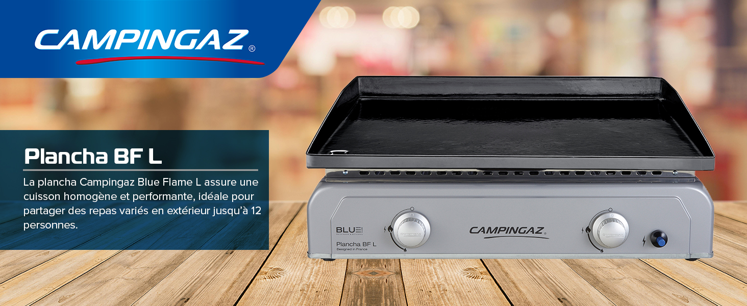 Le texte indique « CAMPINGAZ » et « Plancha BF'L ». Réchaud de camping compact avec deux boutons de commande, surface de cuisson métallique et panneau d'information sur le produit sur étiquette bleue.